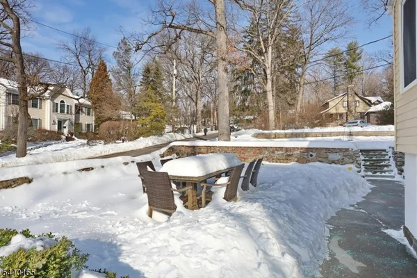 a view of a house with a yard covered in snow