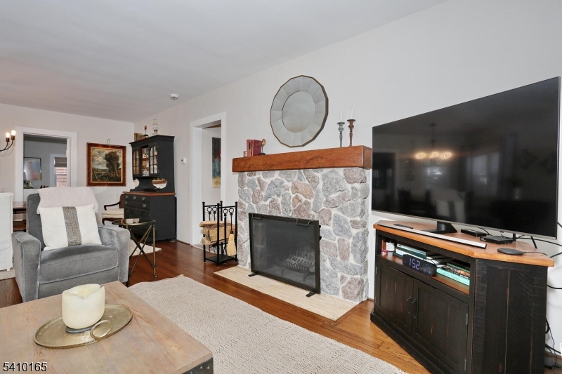 2 Maysenger Road Mahwah, NJ 07430 - Photo 3 of 28 a living room with furniture a fireplace and a flat screen tv