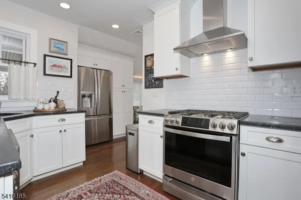 a kitchen with stainless steel appliances a stove a sink and a refrigerator