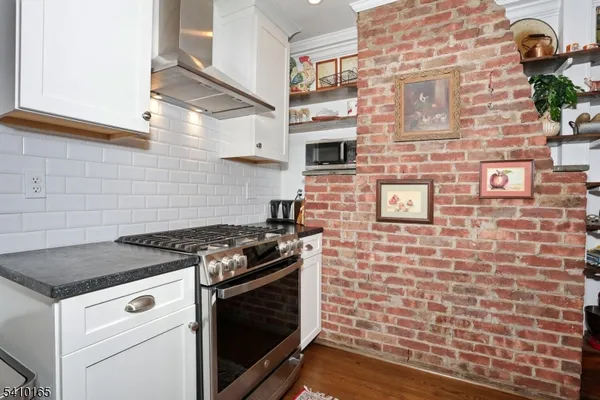 a stove top oven sitting inside of a kitchen