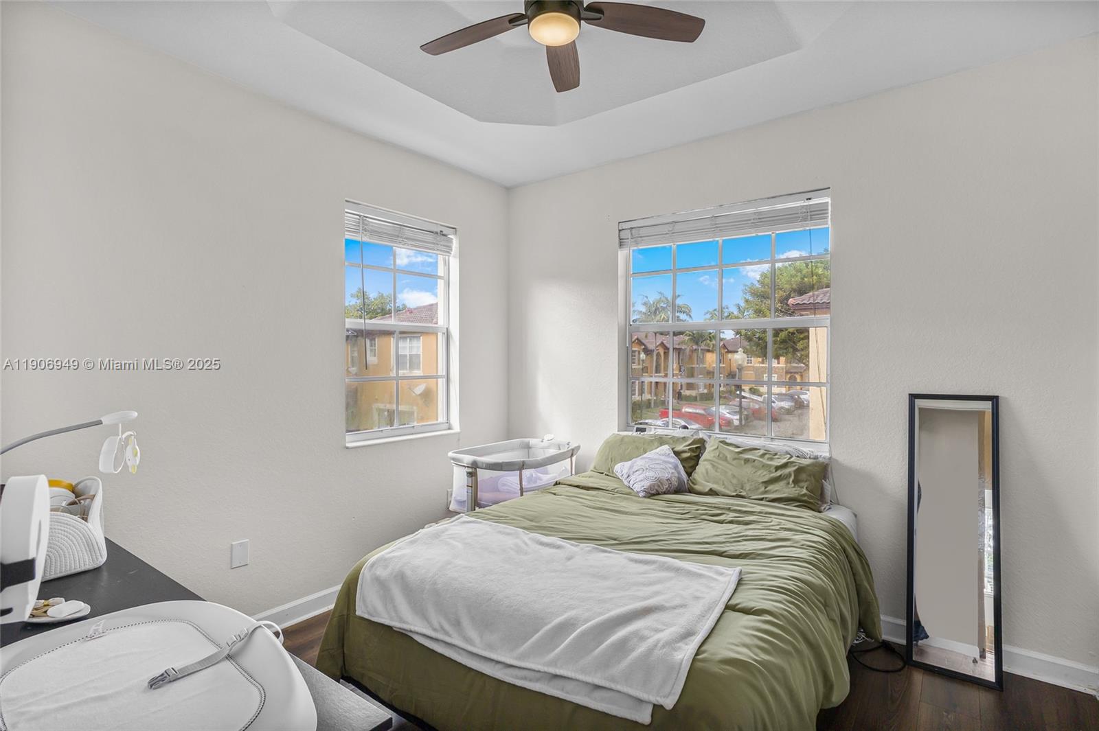 9239 Southwest 227th Street, Unit 1 Cutler Bay, FL 33190 - Photo 18 of 37 a bedroom with a bed and a chandelier