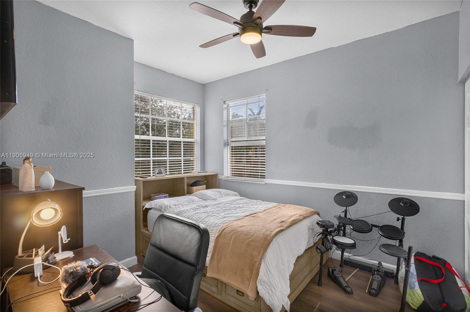 9239 Southwest 227th Street, Unit 1 Cutler Bay, FL 33190 - Photo 20 of 37 a bedroom with a bed and a chandelier