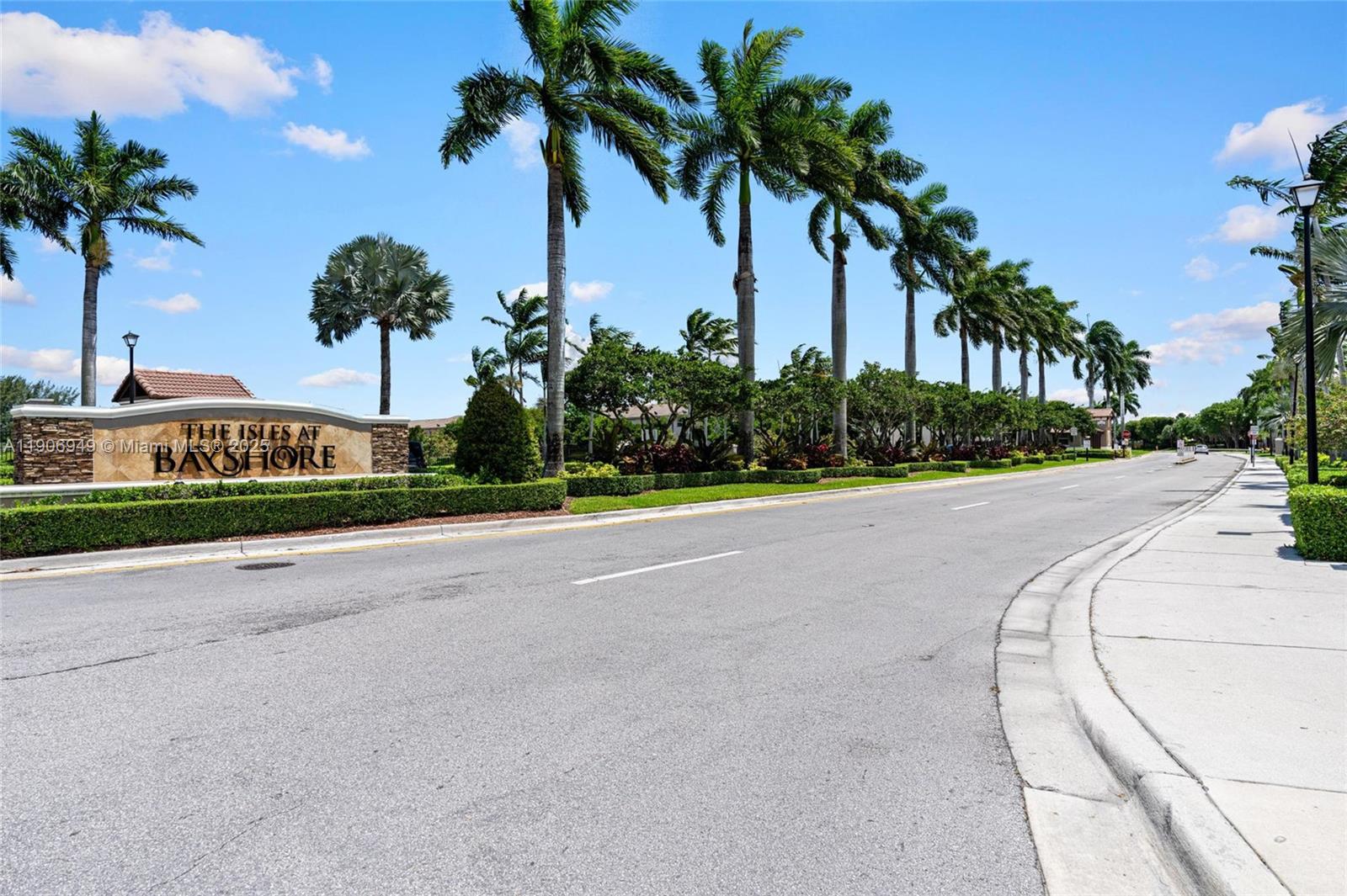 9239 Southwest 227th Street, Unit 1 Cutler Bay, FL 33190 - Photo 36 of 37 a front view of a house with palm trees