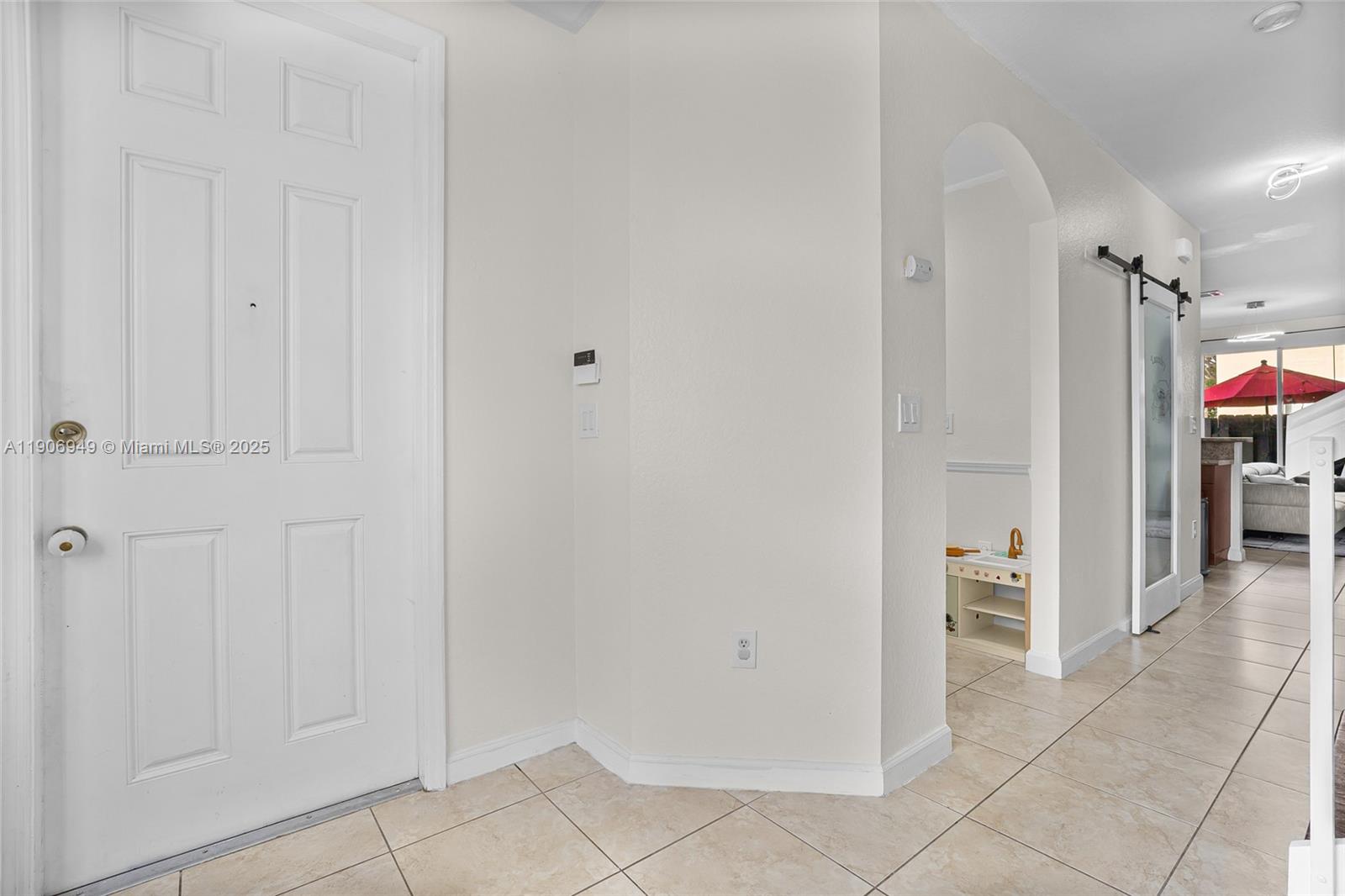 9239 Southwest 227th Street, Unit 1 Cutler Bay, FL 33190 - Photo 6 of 37 a view of a hallway with some storage area
