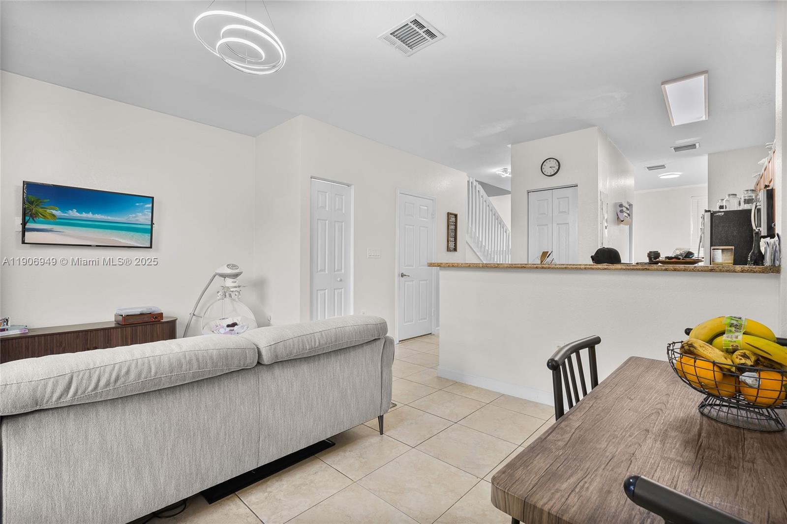 9239 Southwest 227th Street, Unit 1 Cutler Bay, FL 33190 - Photo 9 of 37 a living room with furniture and painting on the wall