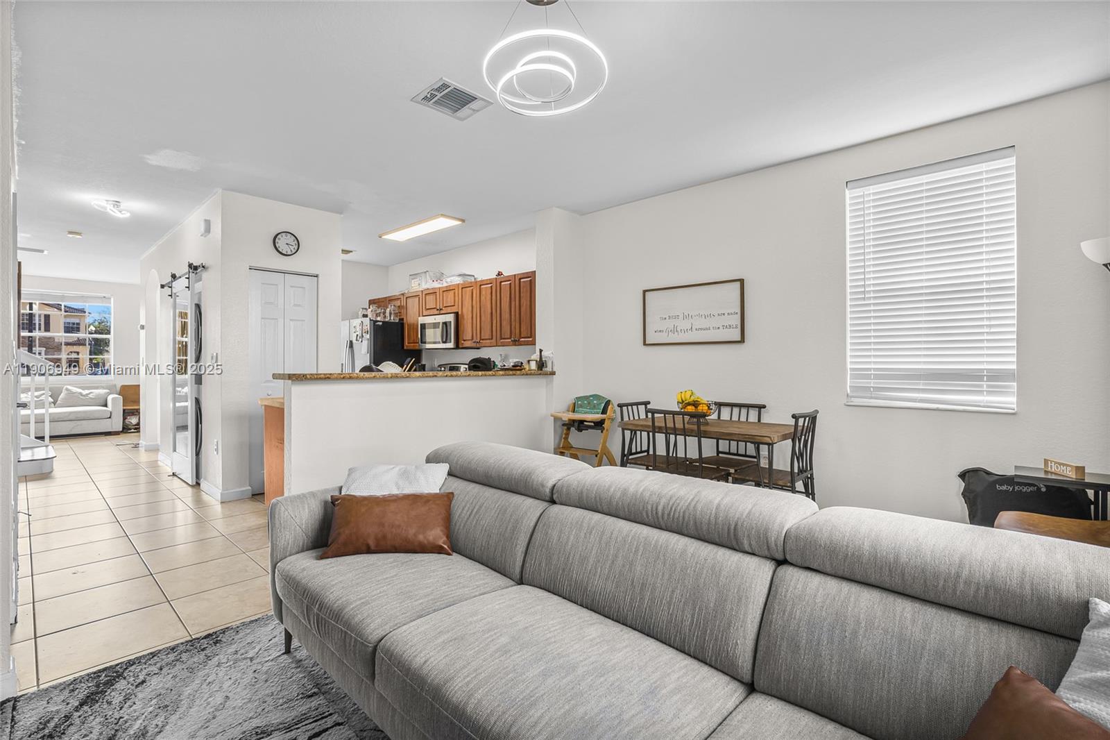 9239 Southwest 227th Street, Unit 1 Cutler Bay, FL 33190 - Photo 10 of 37 a living room with furniture kitchen view and a window