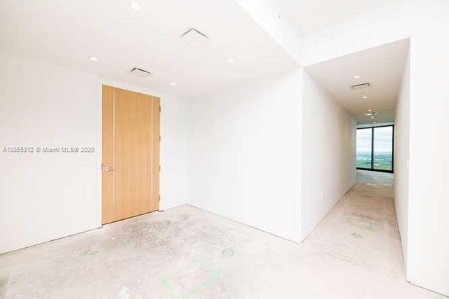 a view of a kitchen with kitchen island a sink a counter top space and appliances