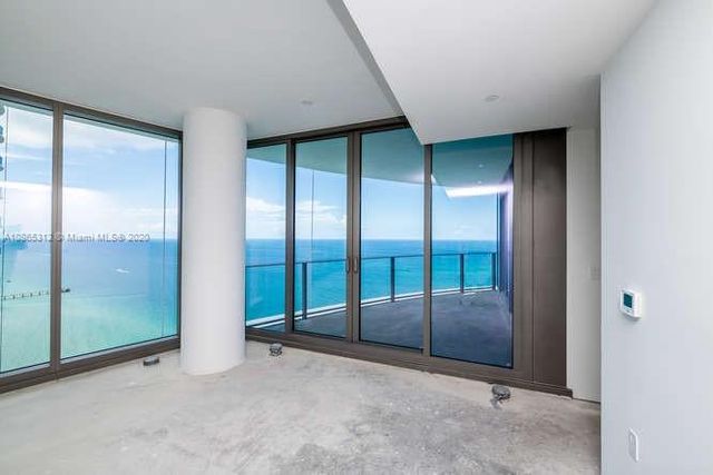 a large white kitchen with a sink and cabinets