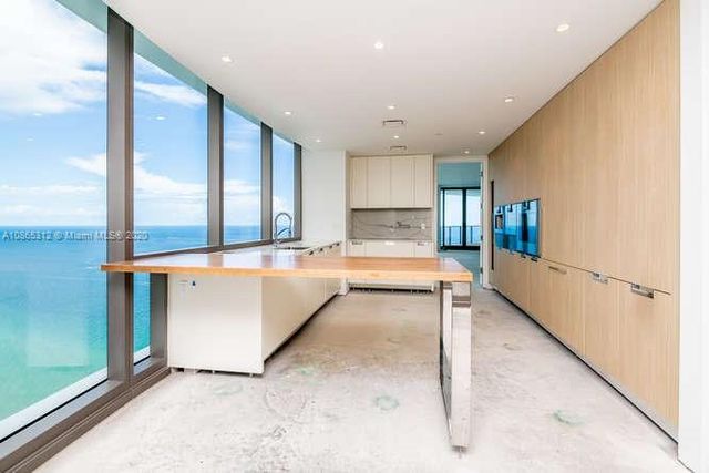 an empty room with sliding glass door and mountain view