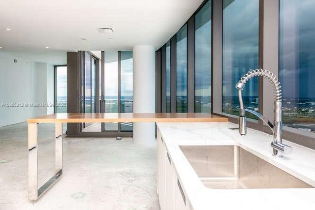 an empty room with large windows