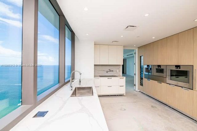 a view of an empty room with windows