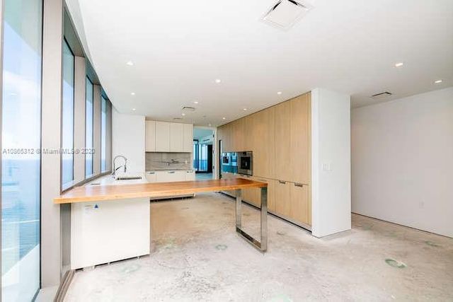 a view of an empty room with glass door