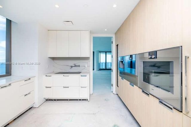 a spacious bathroom with a granite countertop sink mirror and shower