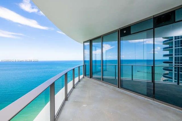 a view of an empty room with glass windows