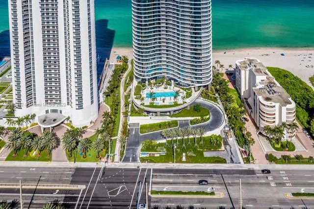 a living room with furniture a rug and a large window
