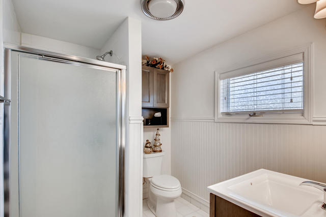 161 Washington Circle Lake Forest, IL 60045 - Photo 22 of 25 a bathroom with a granite countertop sink toilet and a shower