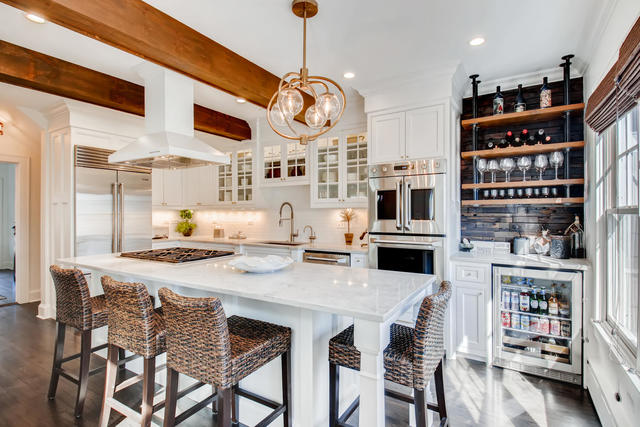 161 Washington Circle Lake Forest, IL 60045 - Photo 6 of 25 a kitchen with stainless steel appliances granite countertop a table chairs and a refrigerator