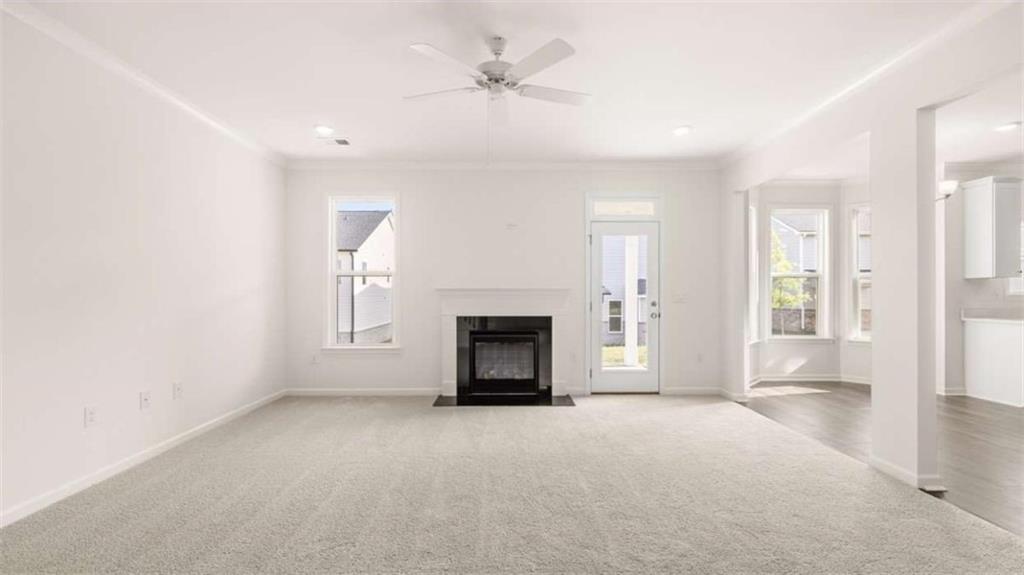 13599 Whitman Lane Covington, GA 30014 - Photo 18 of 51 an empty room with windows and fireplace