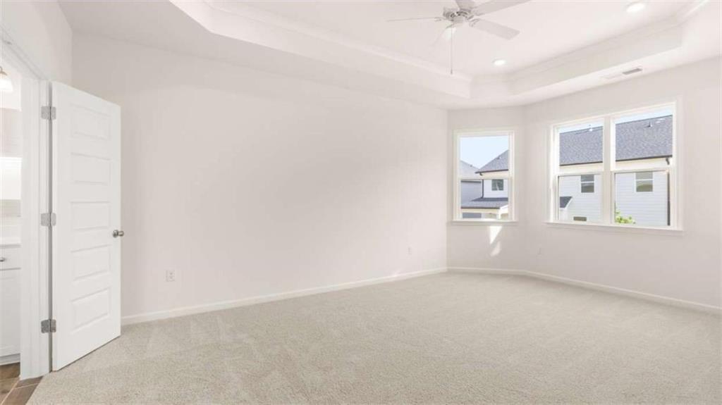 13599 Whitman Lane Covington, GA 30014 - Photo 22 of 51 an empty room with windows and ceiling fan