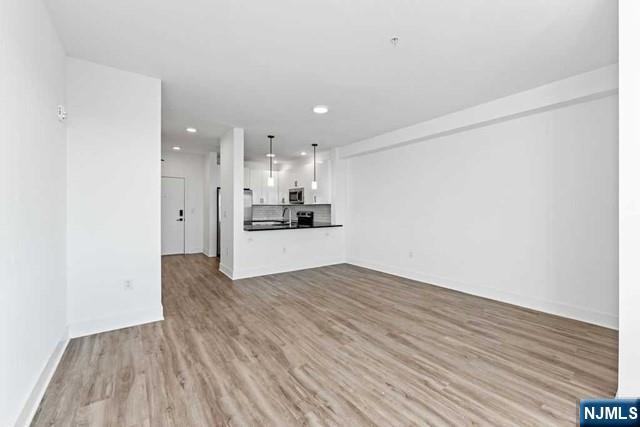 520 Cliff Street, Unit 215 Fairview, NJ 07022 - Photo 3 of 22 a view of a kitchen with wooden floor