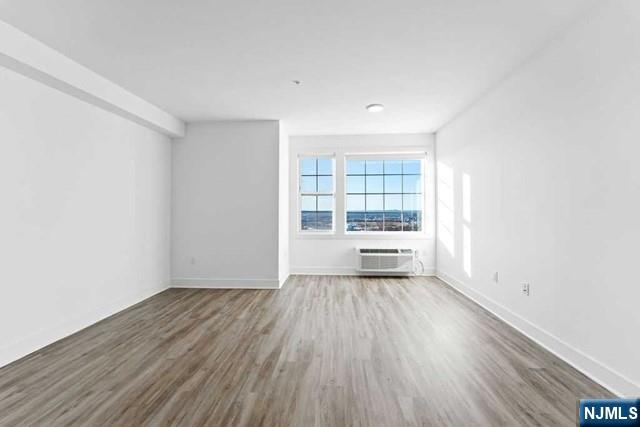 520 Cliff Street, Unit 215 Fairview, NJ 07022 - Photo 4 of 22 wooden floor in an empty room with a window