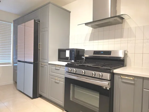 a kitchen with stainless steel appliances granite countertop a refrigerator and a sink