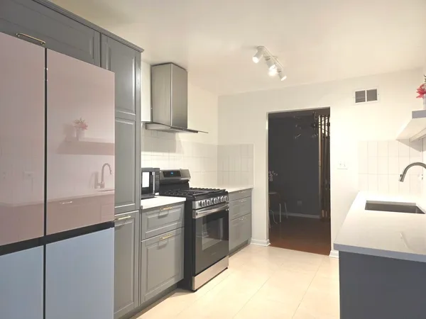 a kitchen with refrigerator and microwave