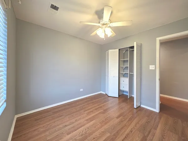 a bathroom with a granite countertop sink a toilet and a mirror