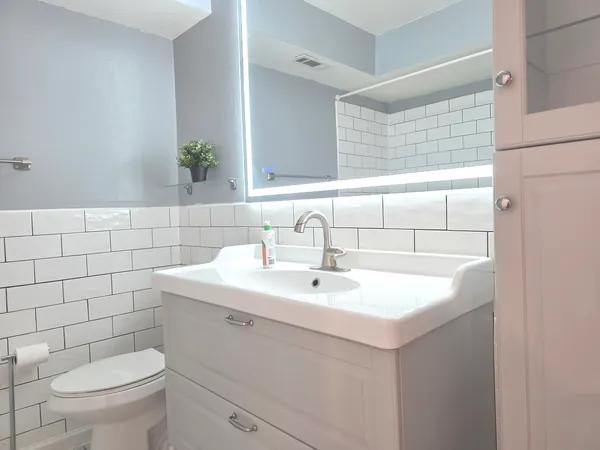 a bathroom with a sink a toilet and bathtub