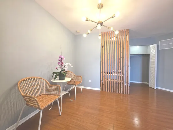 a view of an empty room with wooden floor