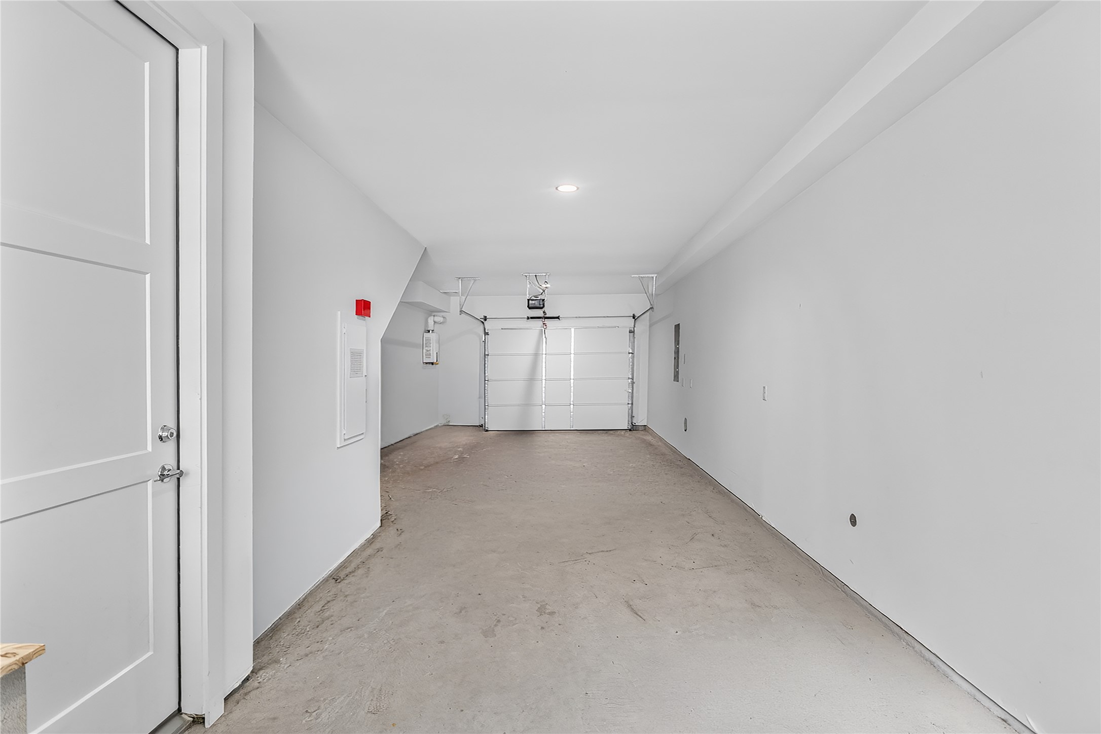2805 McCurdy Street, Unit 14 Austin, TX 78723 - Photo 14 of 40 A spacious, clean garage with a concrete floor provides ample utility and storage space.