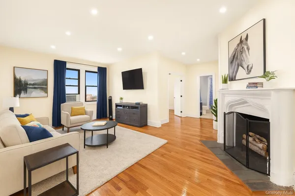 a living room with furniture a fireplace and a flat screen tv