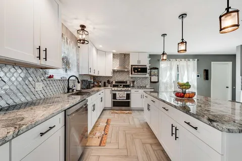 a kitchen with stainless steel appliances granite countertop a sink and cabinets