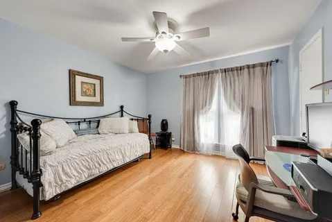 a spacious bedroom with a bed and a chandelier