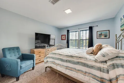 a bedroom with a bed and a television