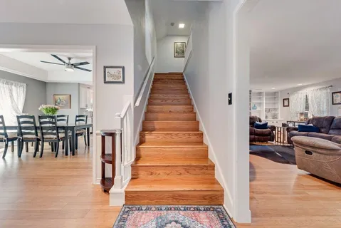 a view of entryway and hall with wooden floor