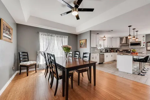 a view of a dining room with furniture and wooden floor
