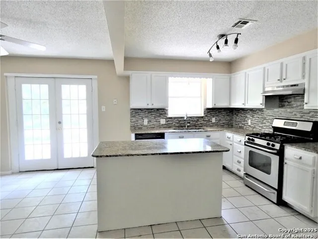 a small space with a fan and a window