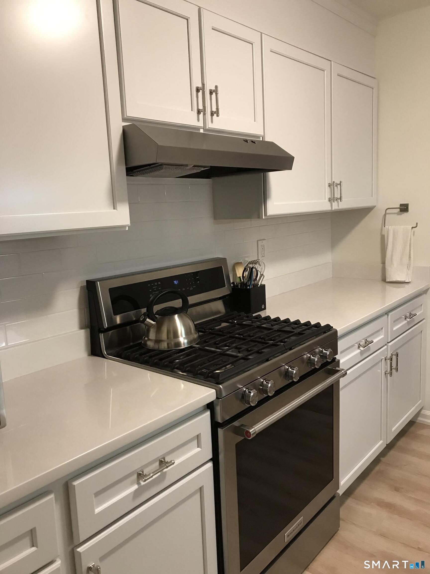 449 The Meadows Enfield, CT 06082 - Photo 2 of 11 a stove top oven sitting inside of a kitchen