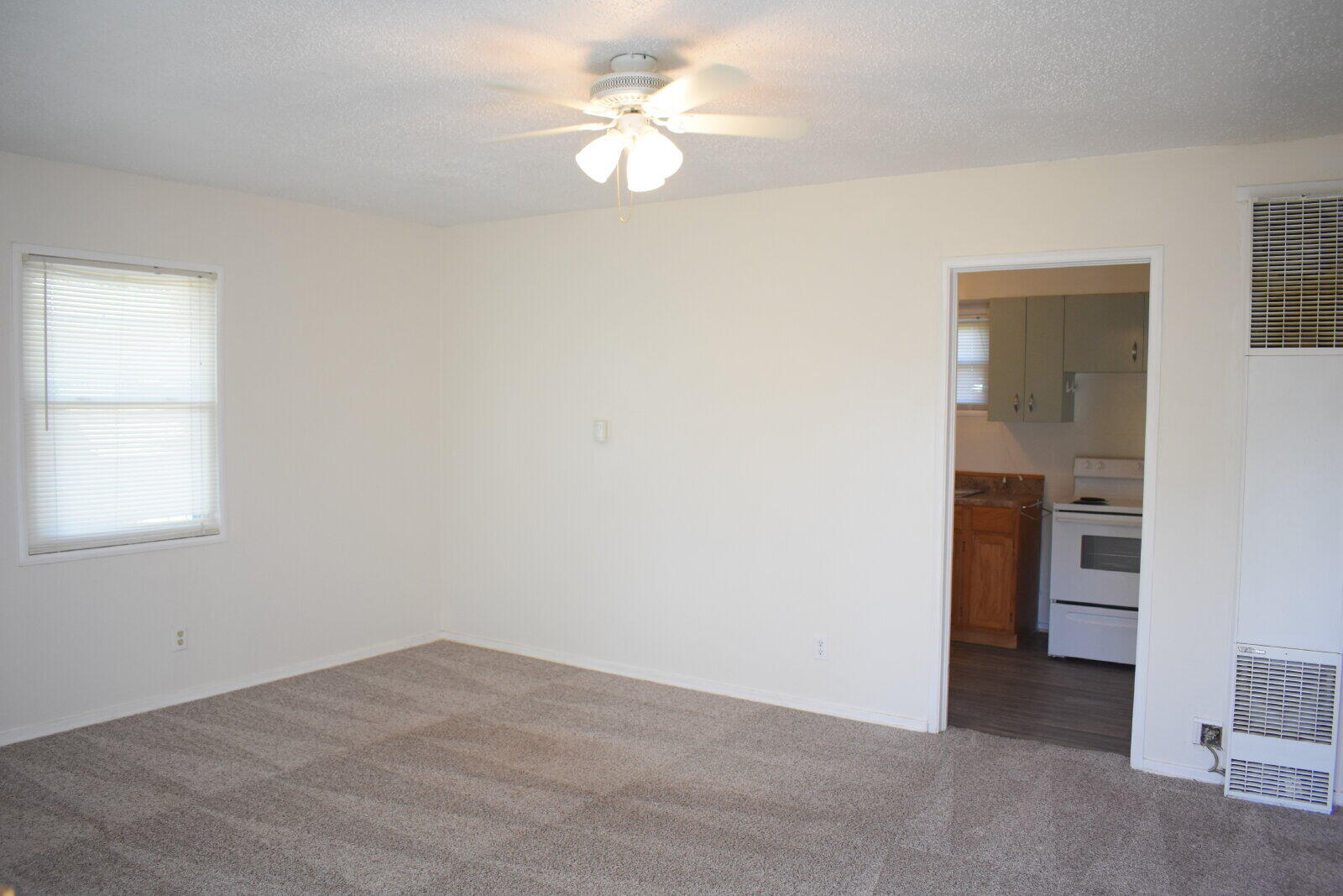 3718 31st Street Lubbock, TX 79410 - Photo 2 of 10 an empty room with a window and a ceiling fan