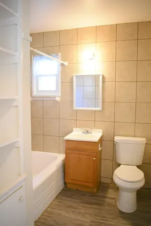 a bathroom with a toilet a sink and bathtub