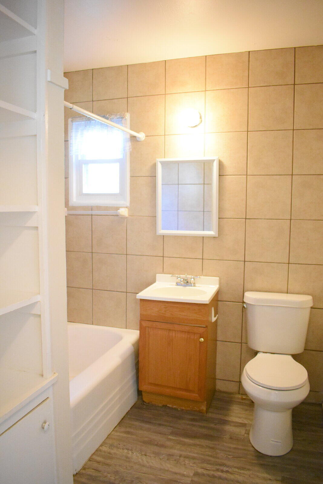 3718 31st Street Lubbock, TX 79410 - Photo 8 of 10 a bathroom with a toilet a sink and bathtub