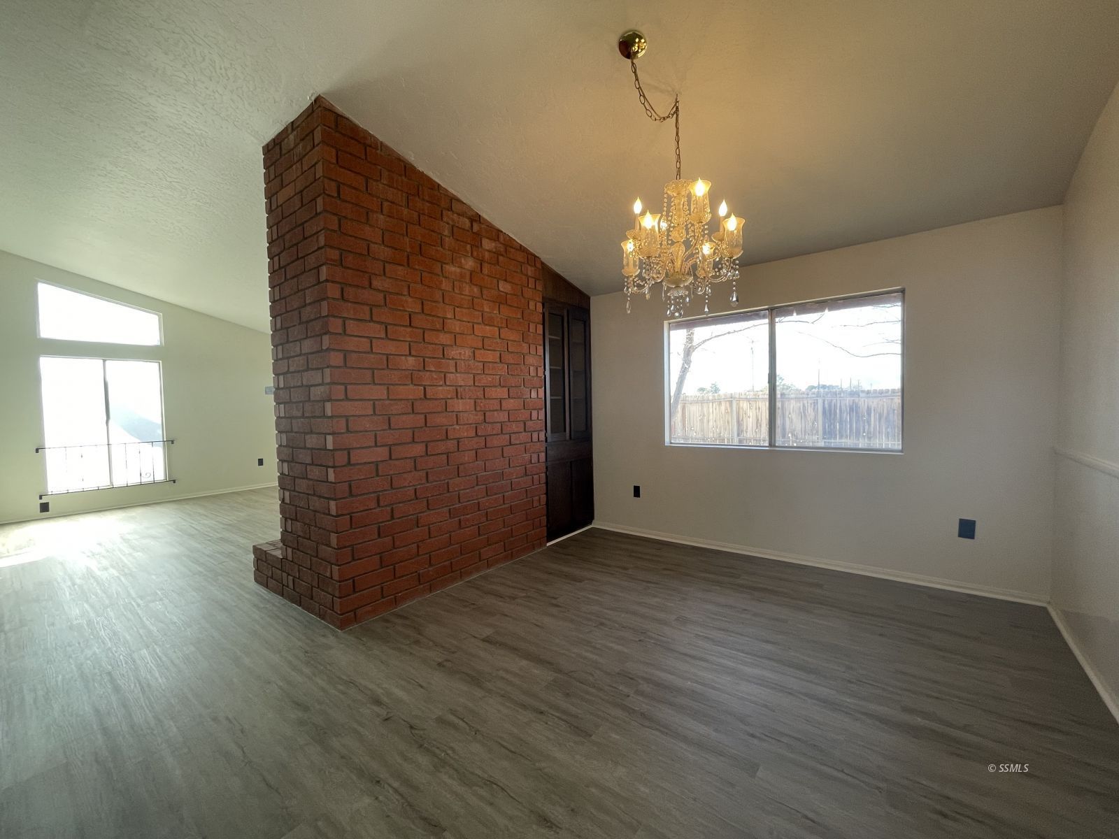 1562 West Reeves Avenue Ridgecrest, CA 93555 - Photo 4 of 45 a view of an empty room with wooden floor and a window