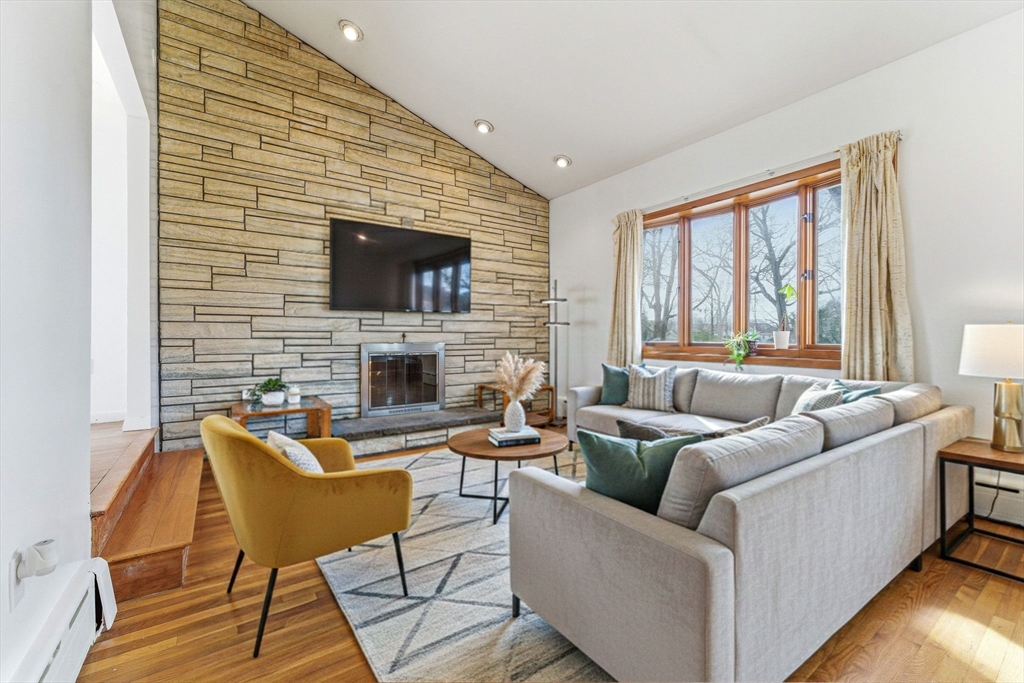 a living room with fireplace furniture and a flat screen tv