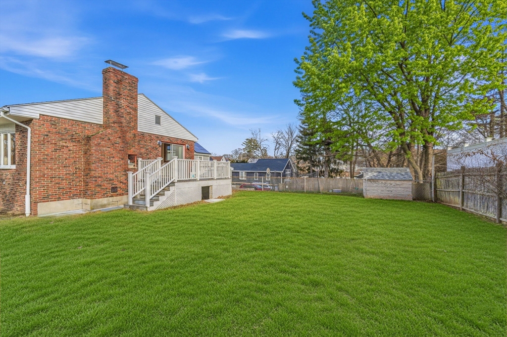 7 Carol Street Stoneham, MA 02180 - Photo 25 of 28 a view of a house with a yard and sitting area