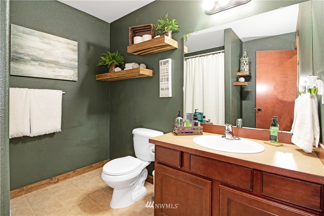16704 Sargent Road Southwest Rochester, WA 98579 - Photo 15 of 40 a bathroom with a toilet a sink and mirror