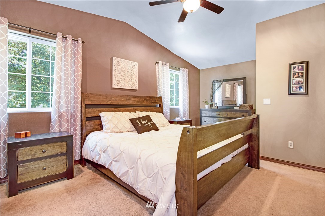 16704 Sargent Road Southwest Rochester, WA 98579 - Photo 20 of 40 a bedroom with a bed and a chandelier