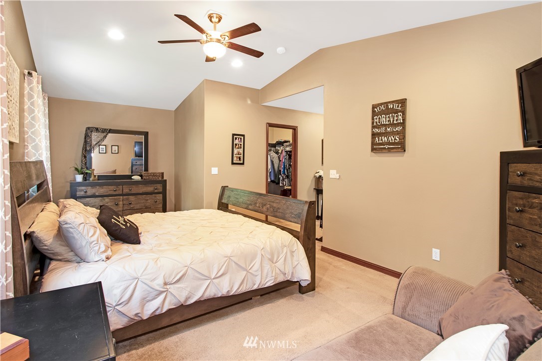 16704 Sargent Road Southwest Rochester, WA 98579 - Photo 22 of 40 a bedroom with a bed and ceiling fan