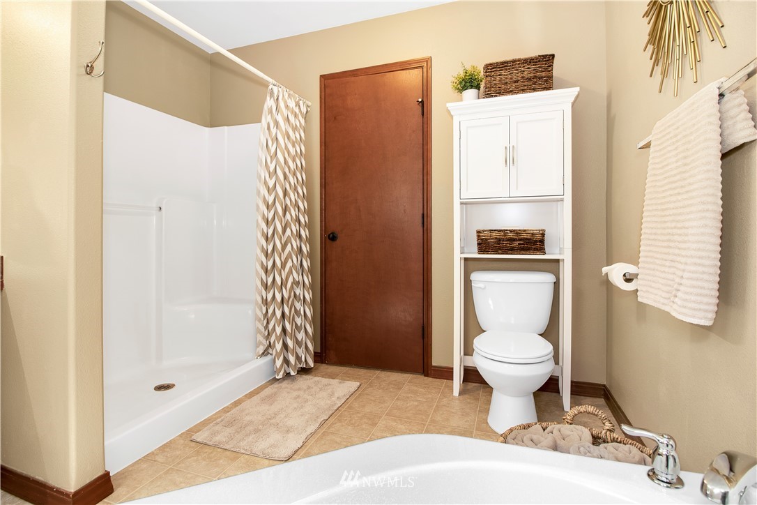 16704 Sargent Road Southwest Rochester, WA 98579 - Photo 24 of 40 a bathroom with a toilet a sink and a shower