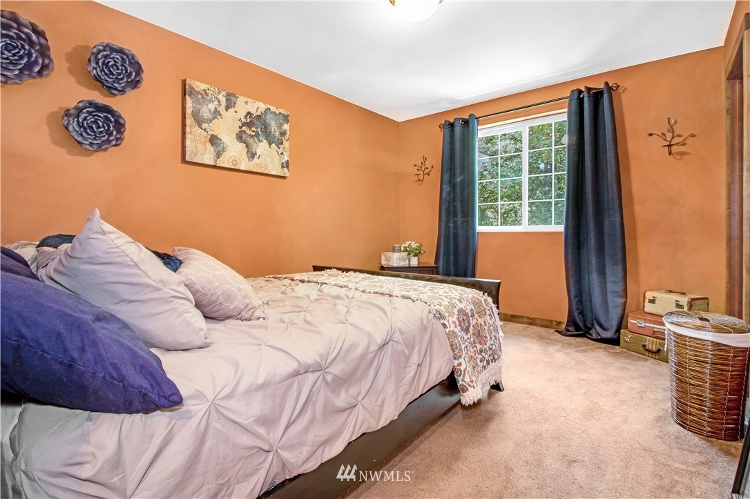 16704 Sargent Road Southwest Rochester, WA 98579 - Photo 26 of 40 a bedroom with a bed and a window